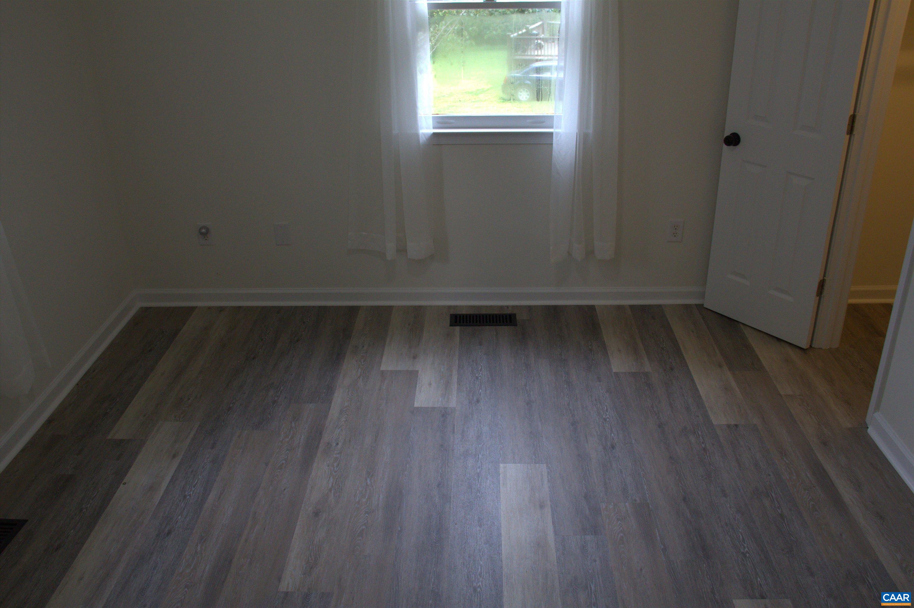 122 Petunia Road Ruckersville, VA 22968 - Photo 34 of 59 an empty room with wooden floor and windows