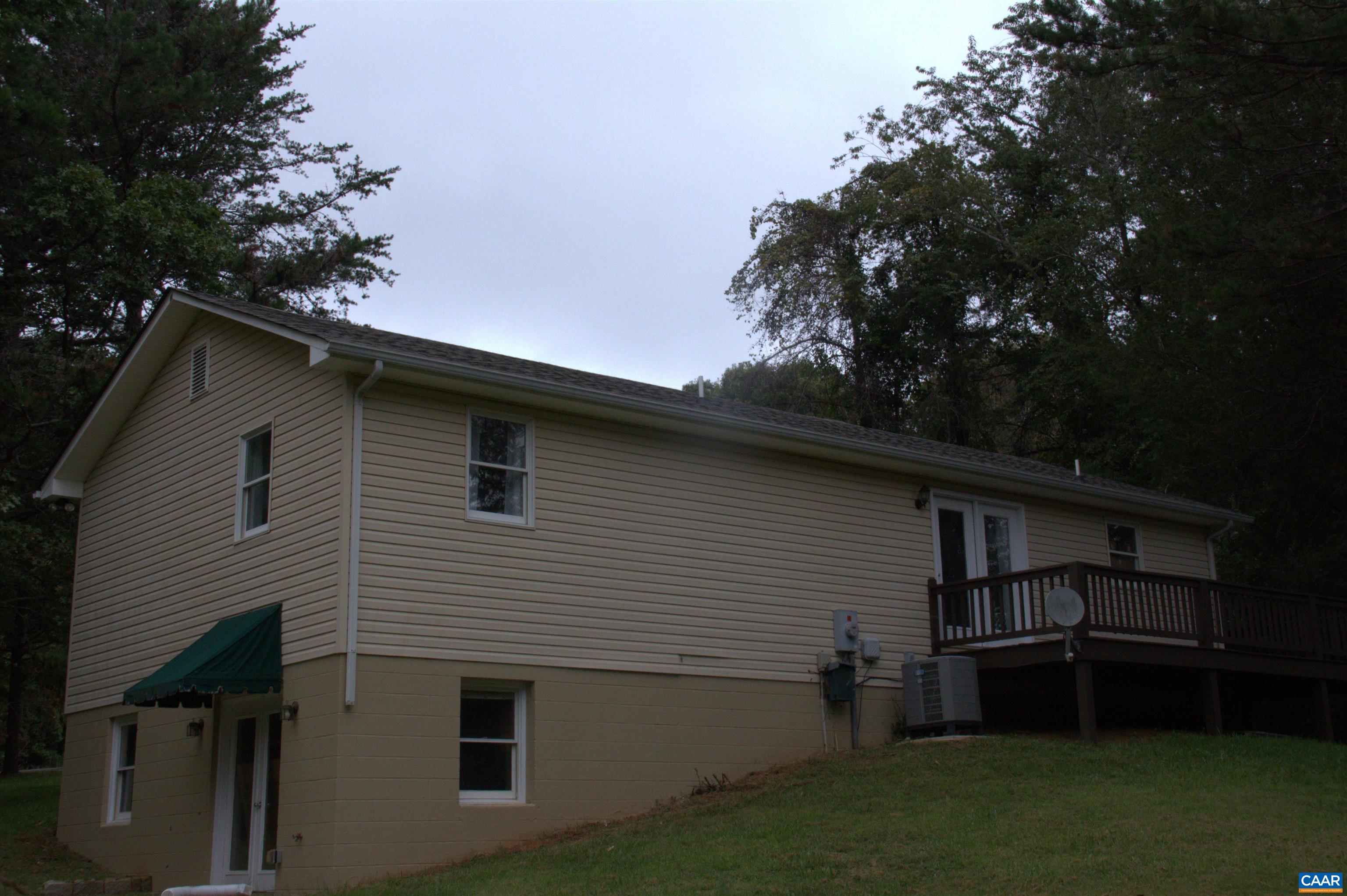 122 Petunia Road Ruckersville, VA 22968 - Photo 9 of 59 a backyard of a house with wooden deck and a tree