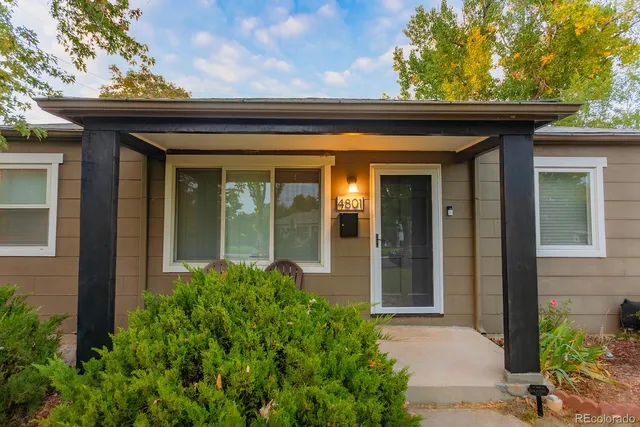 front view of a house with potted plants