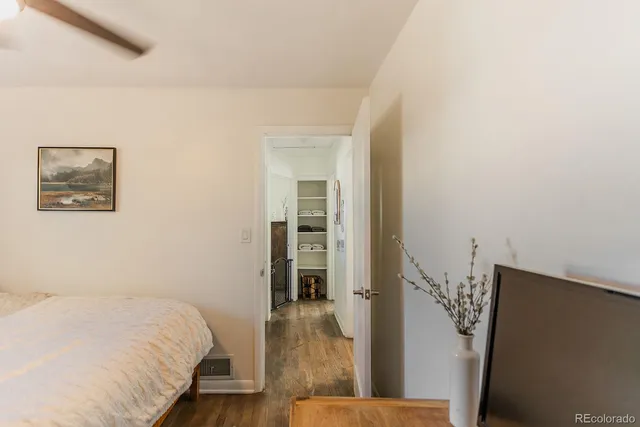 a bed room with a bed and a painting on the wall