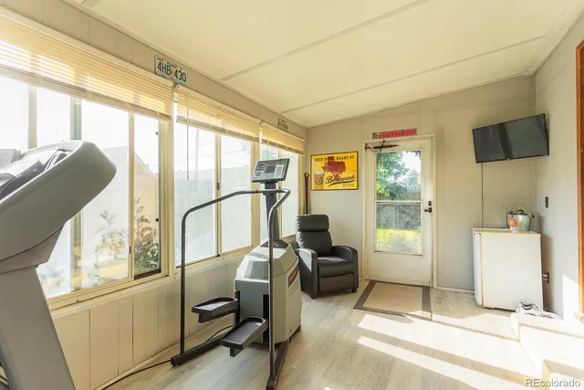 a view of workspace with wooden floor and windows