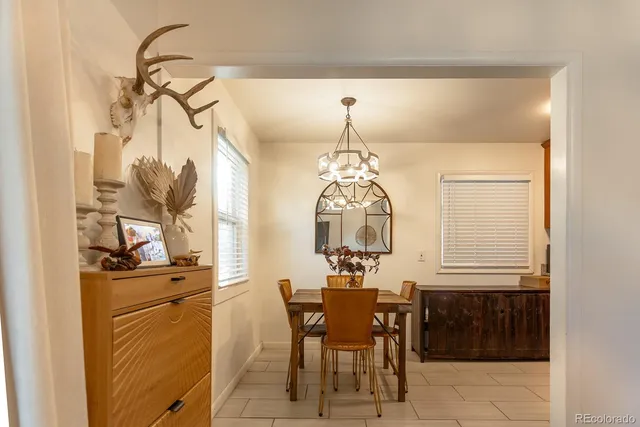 a view of a dining room with furniture and chandelier