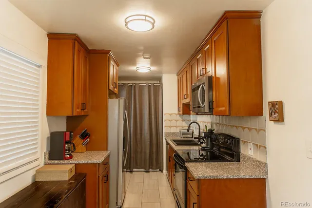 a kitchen with a sink stove and refrigerator