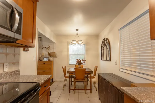 a dining room with furniture and window
