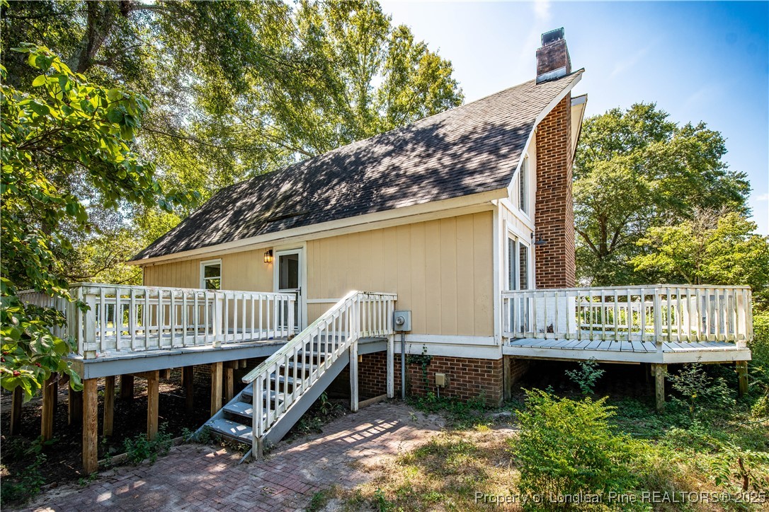 2135 Turnpike Road Raeford, NC 28376 - Photo 12 of 48 a view of front of house with wooden deck and furniture