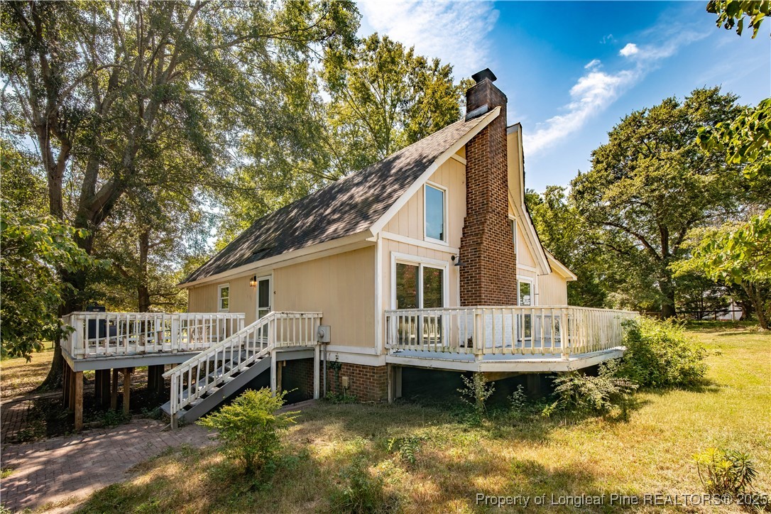 2135 Turnpike Road Raeford, NC 28376 - Photo 2 of 48 a view of a house with wooden deck and furniture