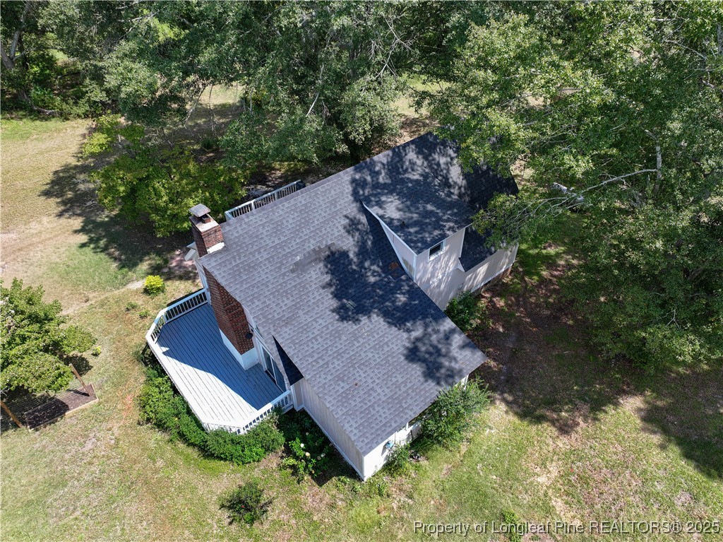 2135 Turnpike Road Raeford, NC 28376 - Photo 7 of 48 an aerial view of a house with a yard and large trees