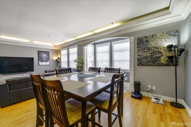 a view of a dining room with furniture and a flat screen tv