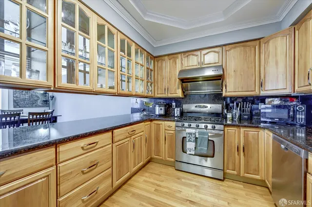 a kitchen with stainless steel appliances granite countertop a stove and a sink