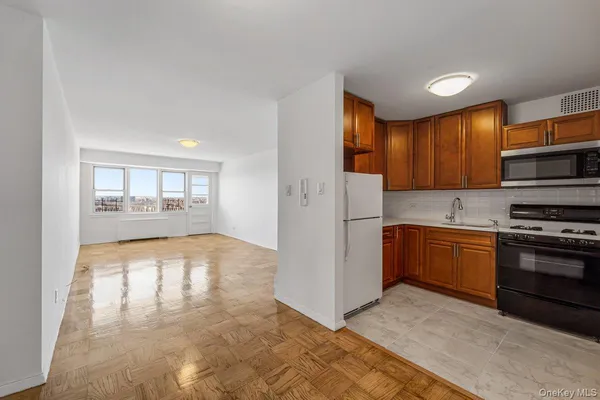 a kitchen with stainless steel appliances granite countertop a refrigerator stove and sink