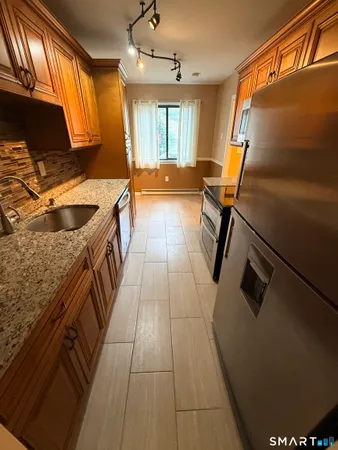 a kitchen with a sink appliances and cabinets