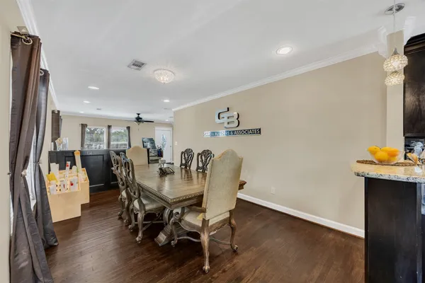 a view of a dining room with furniture and wooden floor
