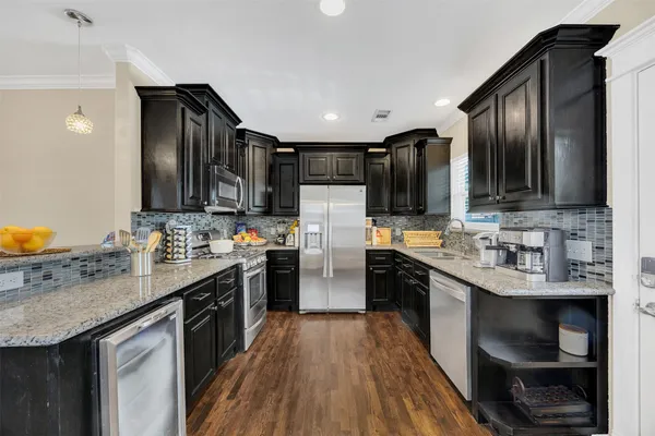 a kitchen with stainless steel appliances granite countertop counter space a sink and cabinets