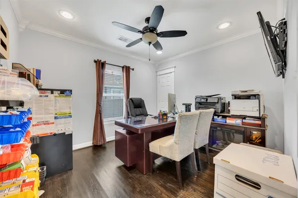a view of a workspace with furniture and a window