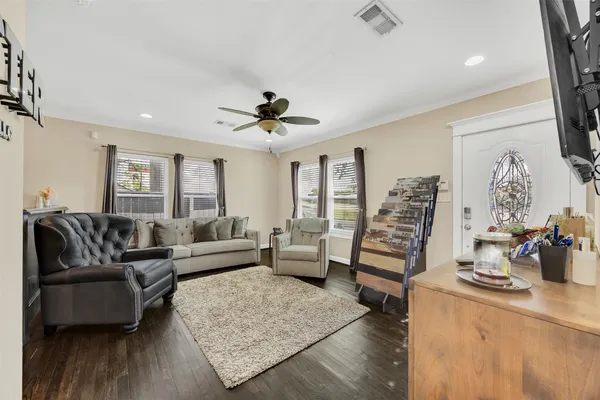 a living room with furniture and wooden floor