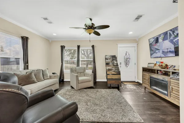 a living room with furniture and wooden floor