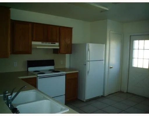 a kitchen with stainless steel appliances a refrigerator and a stove