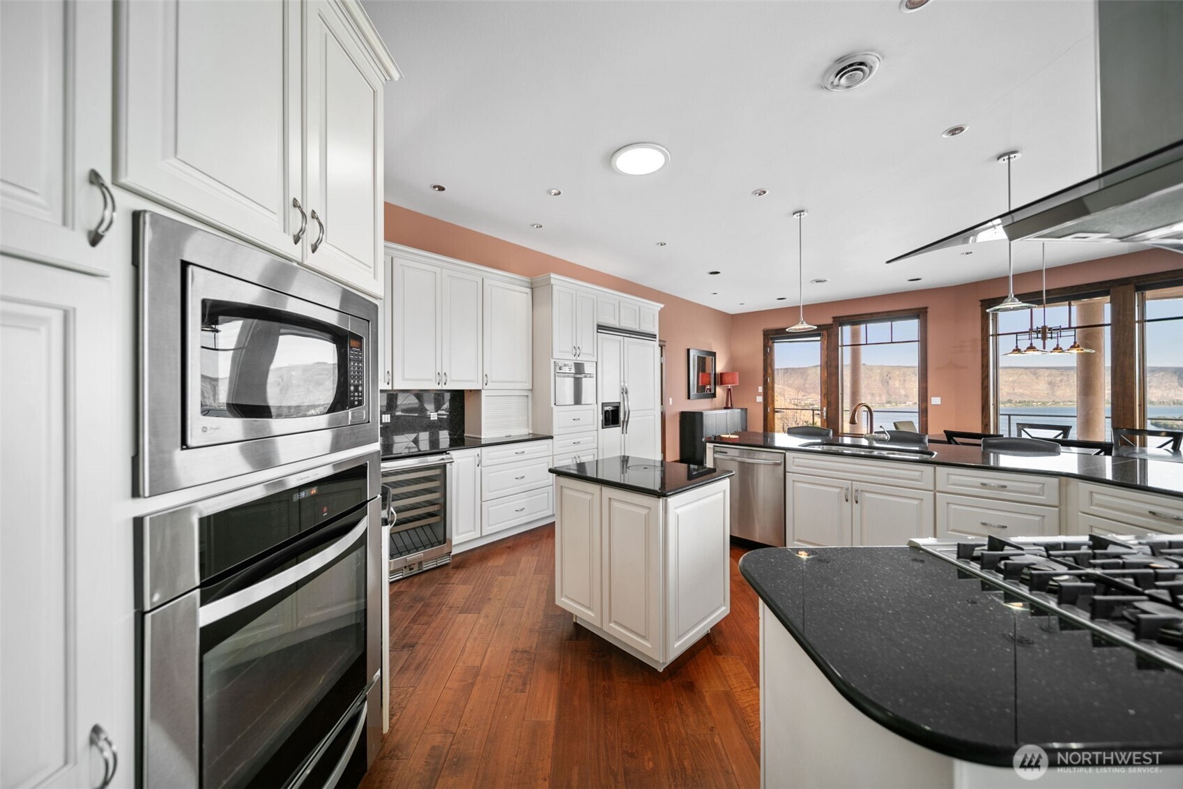 25 Mansfield Road Quincy, WA 98848 - Photo 13 of 40 a kitchen with stainless steel appliances a stove a sink and white cabinets