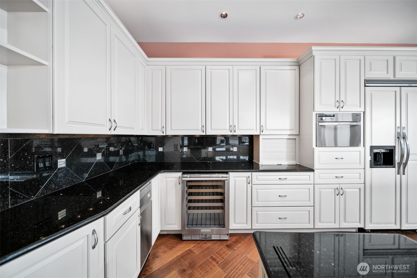 25 Mansfield Road Quincy, WA 98848 - Photo 16 of 40 a kitchen with white cabinets and appliances