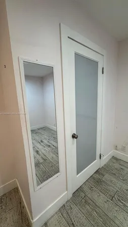 a view of hallway with wooden floor