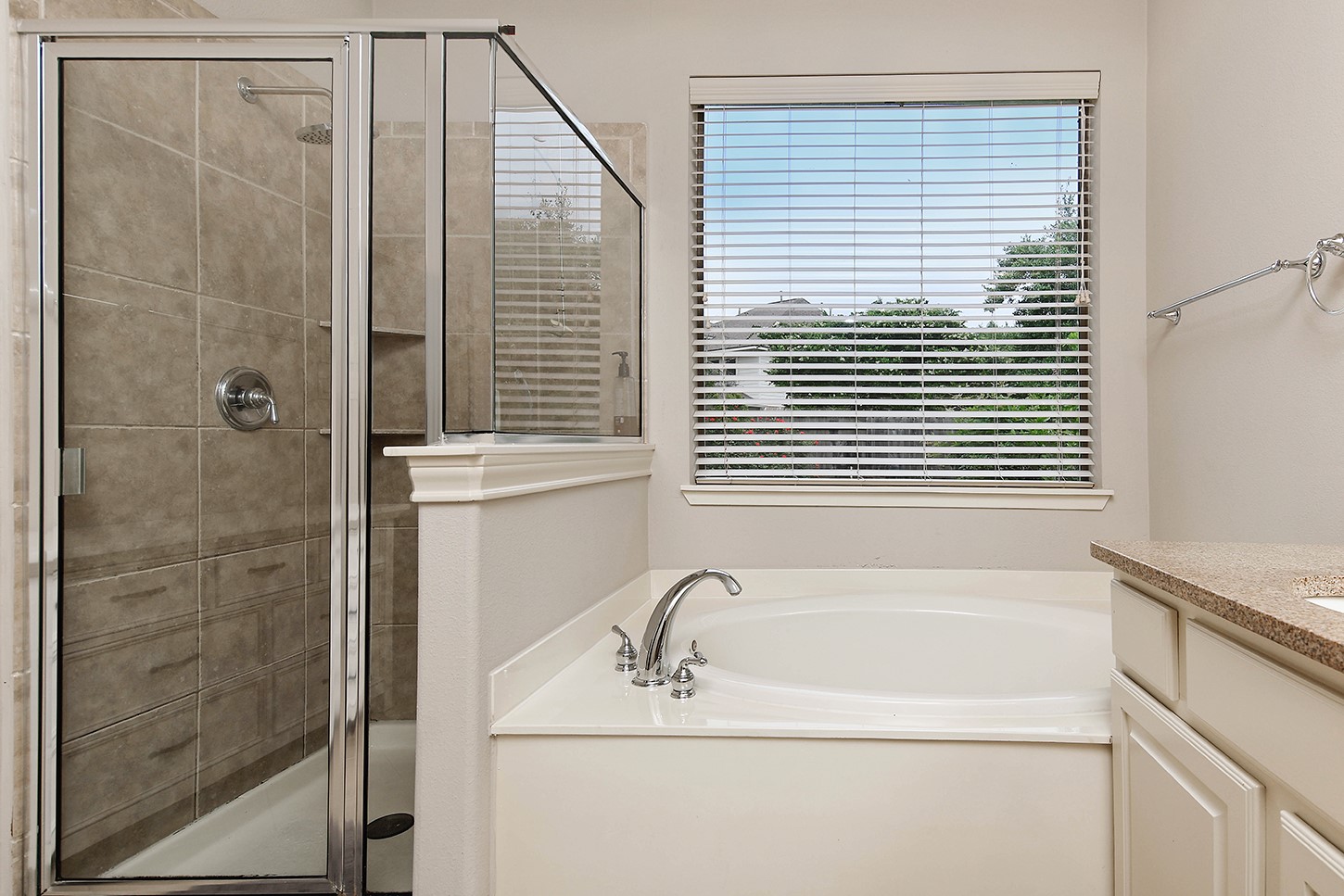 18722 Duke Lake Drive Spring, TX 77388 - Photo 16 of 26 a bathroom with a bathtub and a shower