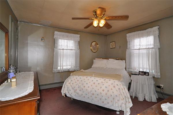 24 Overlook Road Arlington, MA 02474 - Photo 11 of 18 a bedroom with a bed and a chandelier