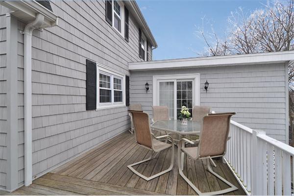 24 Overlook Road Arlington, MA 02474 - Photo 17 of 18 a view of a patio with table and chairs and wooden floor