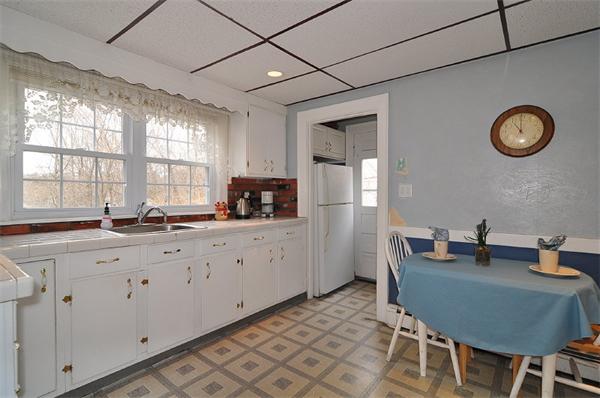 24 Overlook Road Arlington, MA 02474 - Photo 7 of 18 a kitchen with stainless steel appliances granite countertop a sink a stove a dining table and chairs