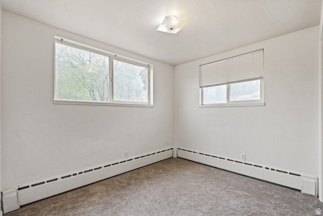 149 West 1600th Street South Mapleton, UT 84664 - Photo 19 of 44 Spare room with carpet floors, a baseboard radiator, and plenty of natural light