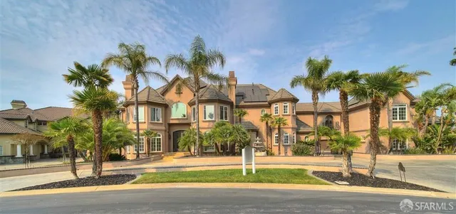 a front view of multiple houses with yard