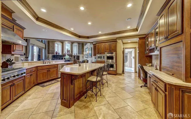 a kitchen with stainless steel appliances granite countertop a sink a stove and a refrigerator