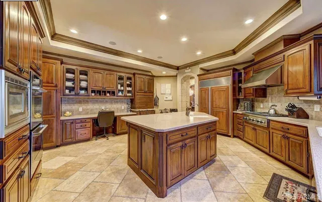 a kitchen with stainless steel appliances granite countertop a stove and a sink