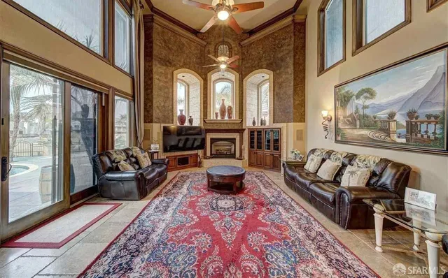 a living room with furniture fireplace and a large window