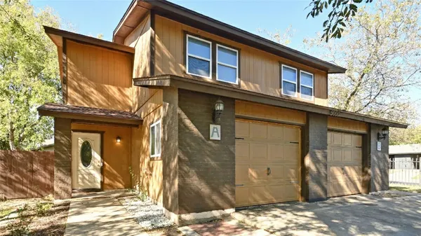 a view of a house with a door and wooden roof