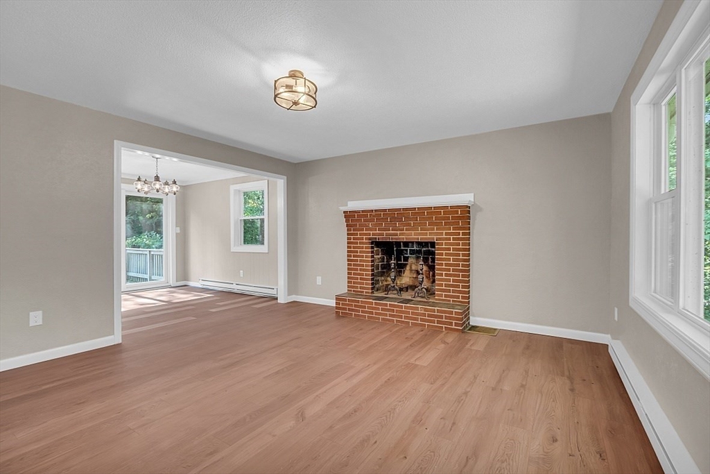 918 New Sherborn Road Athol, MA 01331 - Photo 11 of 41 an empty room with windows and fireplace