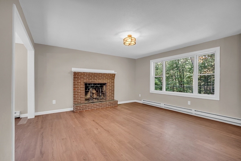 918 New Sherborn Road Athol, MA 01331 - Photo 13 of 41 an empty room with windows and fireplace