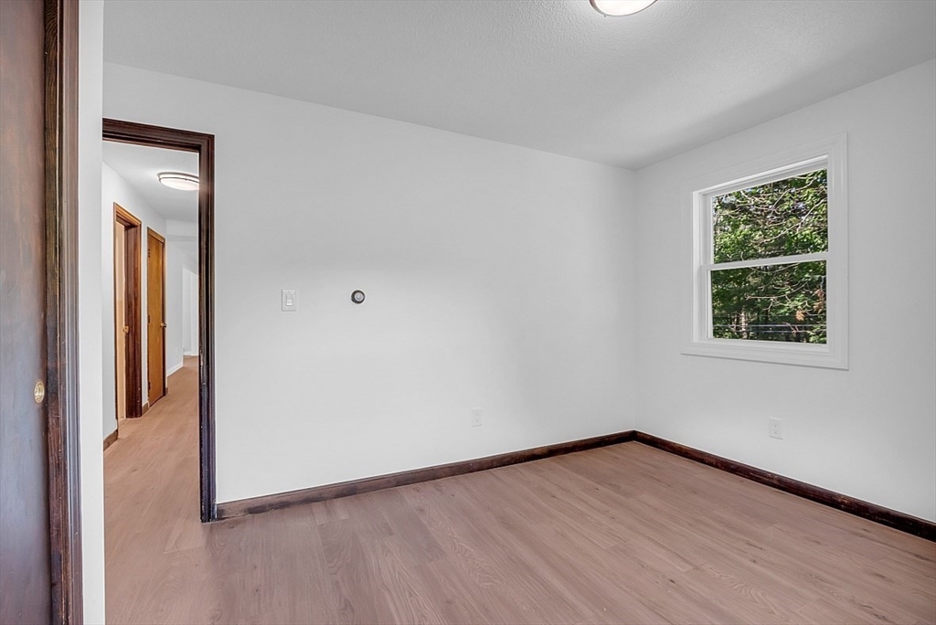 918 New Sherborn Road Athol, MA 01331 - Photo 21 of 41 an empty room with wooden floor and windows
