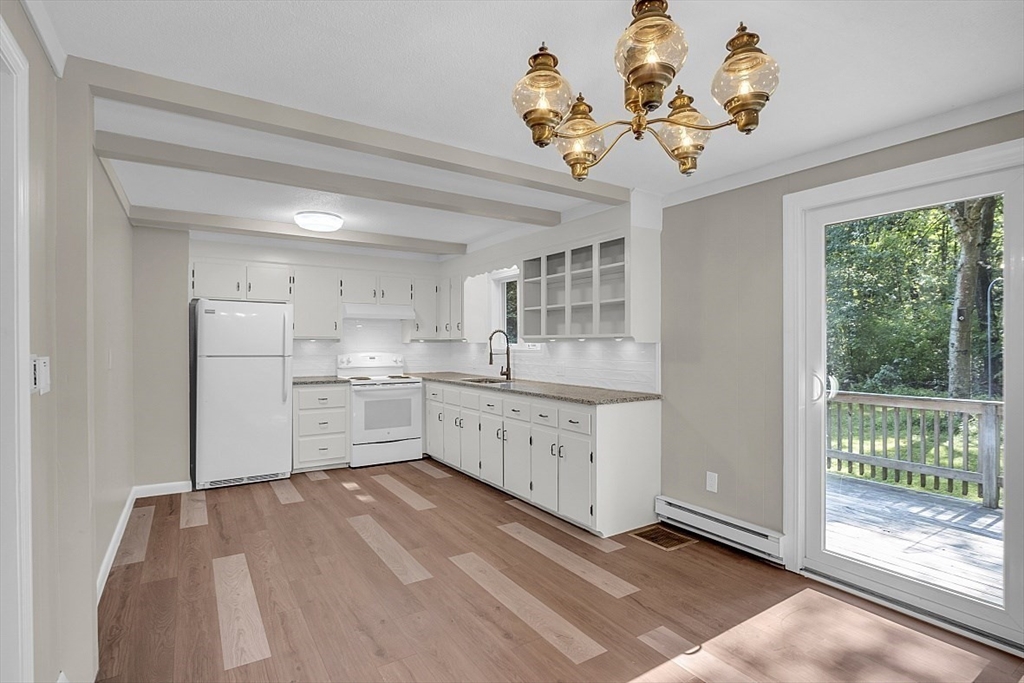 918 New Sherborn Road Athol, MA 01331 - Photo 4 of 41 a kitchen with white cabinets and chandelier