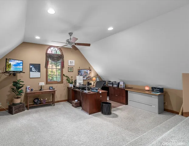 a living room with furniture a flat screen tv and kitchen view