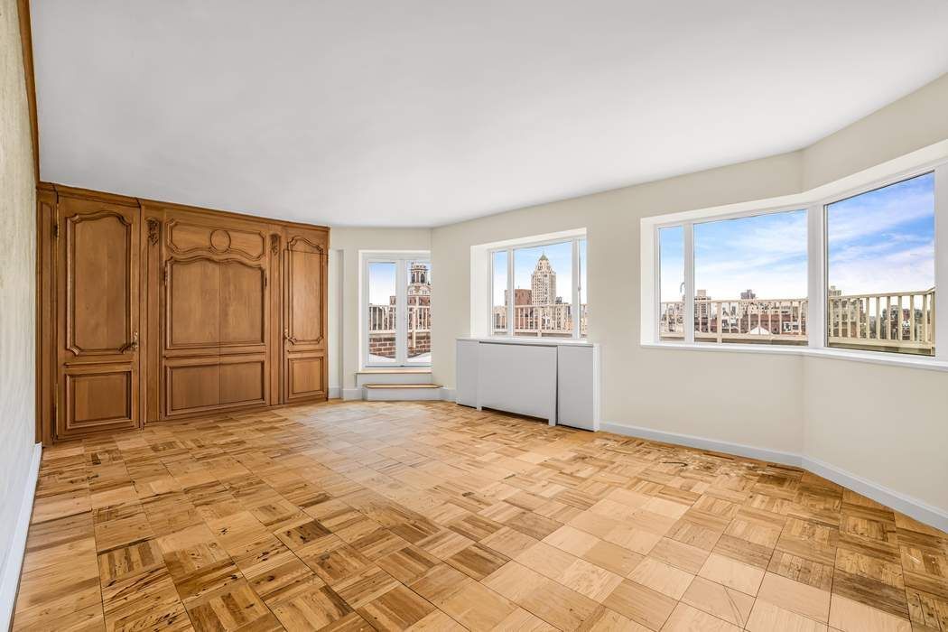 140 East 72nd Street, Unit PH Manhattan, NY 10021 - Photo 8 of 12 a view of a livingroom with wooden cabinets
