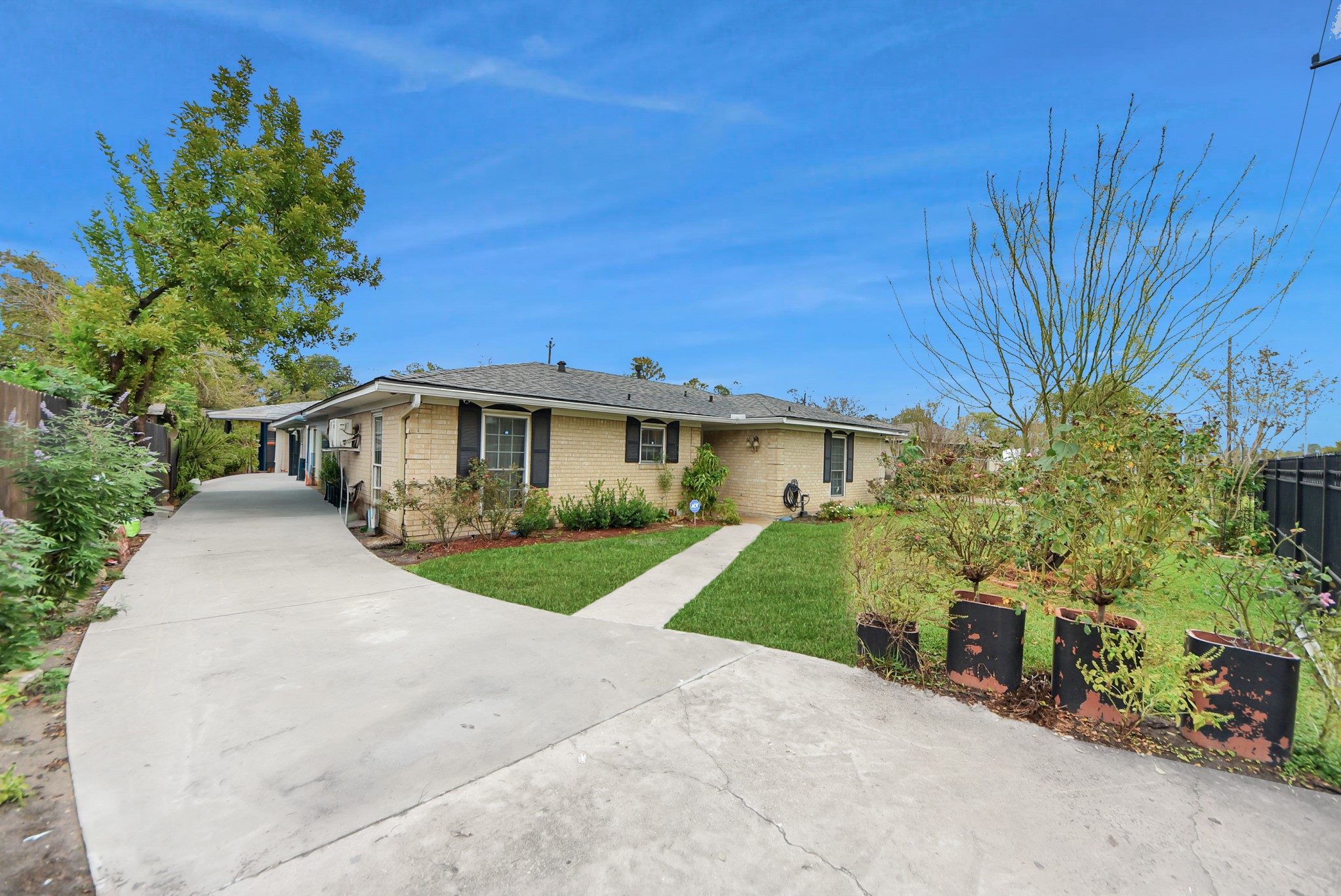 2443 Lauder Road Houston, TX 77039 - Photo 4 of 21 a front view of a house with garden