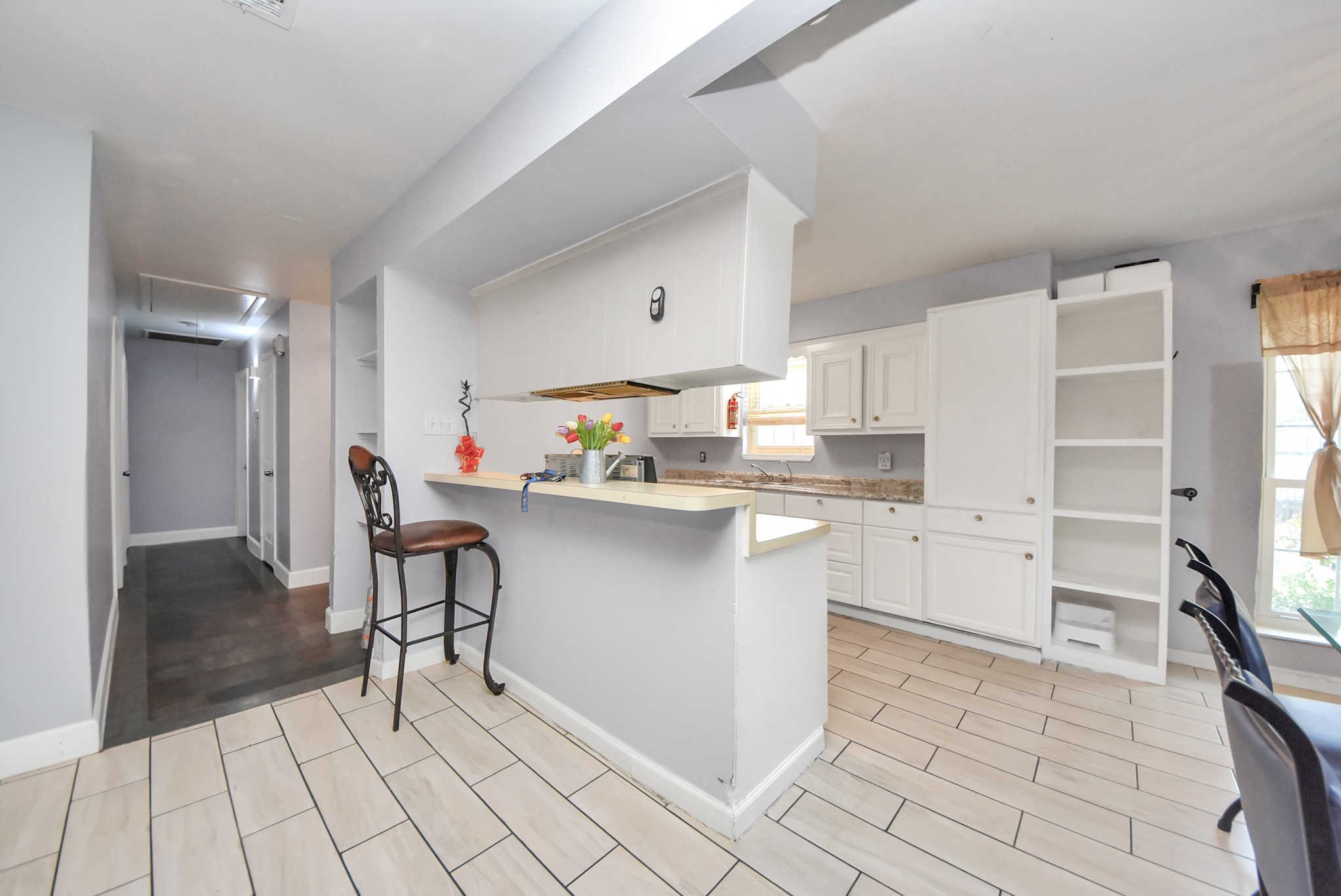 2443 Lauder Road Houston, TX 77039 - Photo 6 of 21 a kitchen with white cabinets and counter space