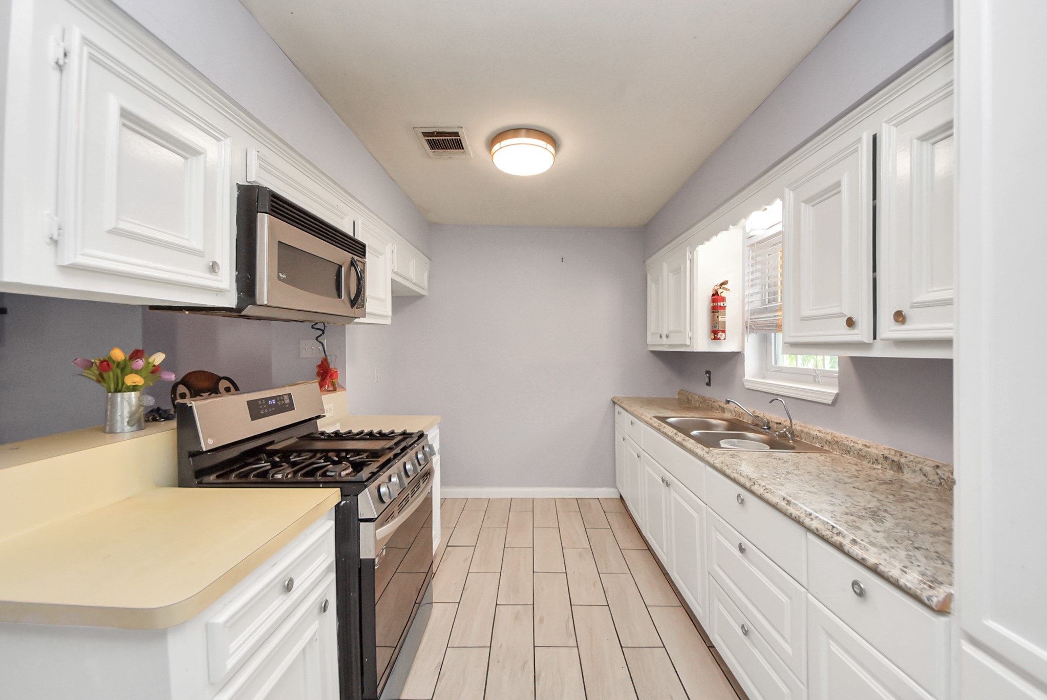 2443 Lauder Road Houston, TX 77039 - Photo 8 of 21 a kitchen with stainless steel appliances granite countertop a sink stove and cabinets