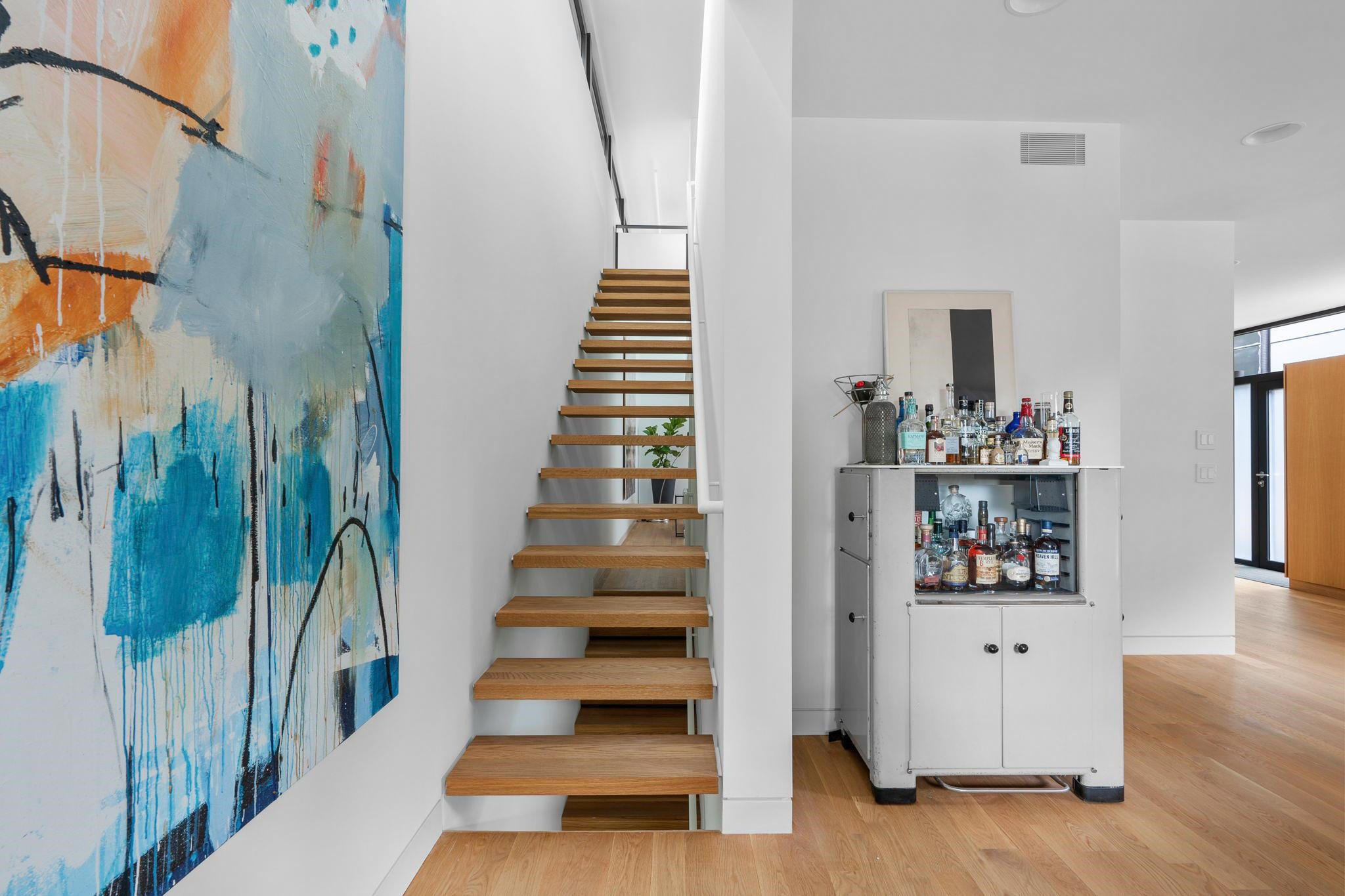 920 Tower Street Raleigh, NC 27607 - Photo 21 of 54 a view of staircase with white walls and wooden floor