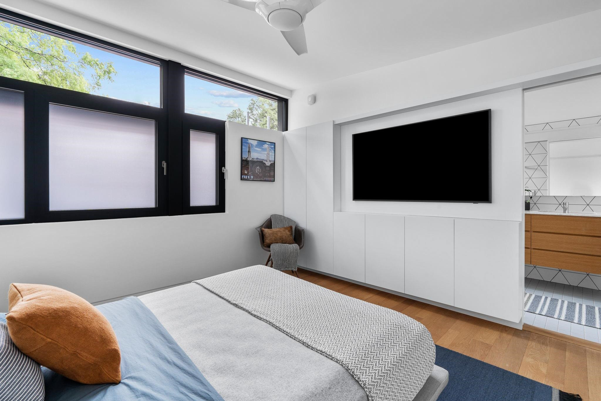 920 Tower Street Raleigh, NC 27607 - Photo 37 of 54 a bedroom with a bed and a flat screen tv