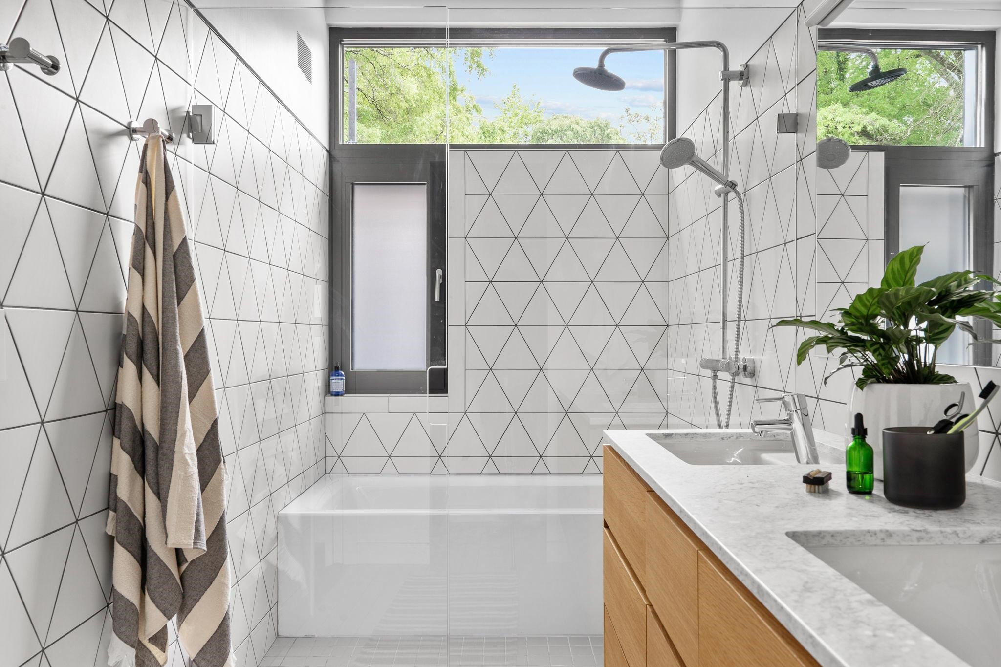 920 Tower Street Raleigh, NC 27607 - Photo 39 of 54 a bathroom with a granite countertop sink a mirror and a shower