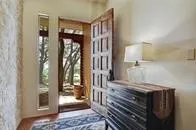 a utility room with stainless steel appliances granite countertop a sink a stove and a window