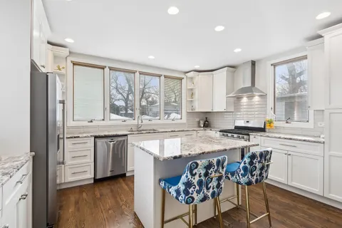 a kitchen with kitchen island sink refrigerator and microwave