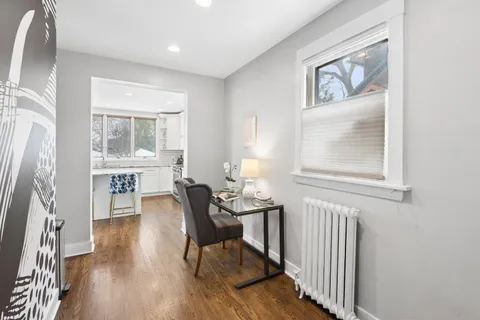 a view of a dining room with furniture and wooden floor