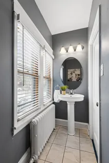 a bathroom with a sink a toilet and a mirror